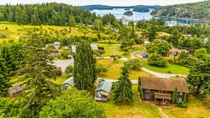 Vista aérea de una zona residencial con casas, una gran masa de agua y un paisaje boscoso.