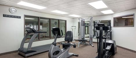 A gym with treadmills, elliptical machines, and weight machines.