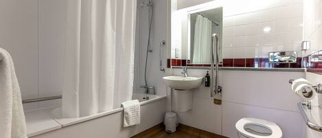 A modern bathroom with a shower, sink, and toilet.
