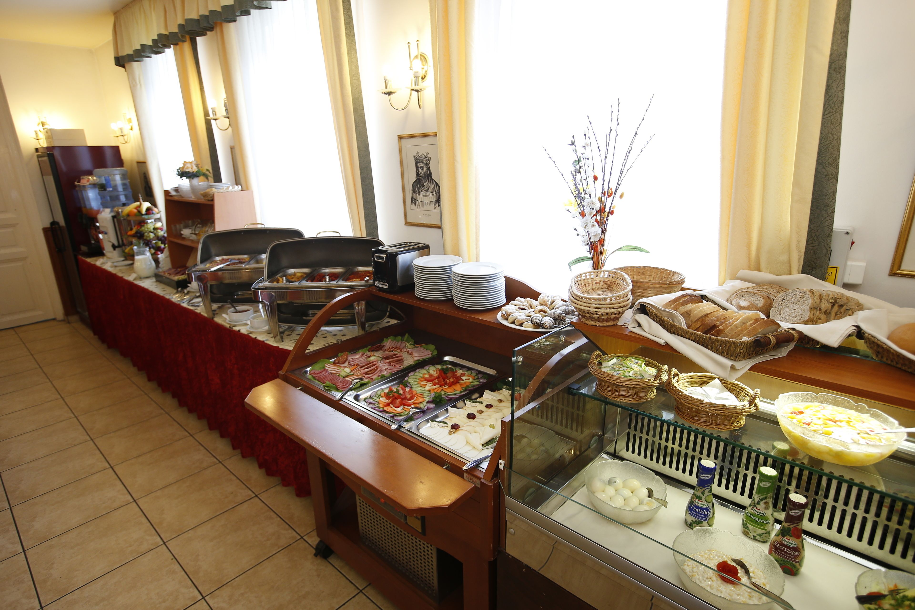 A buffet setup with various food items and condiments.