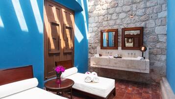 Bathroom features a bathtub, sink, and wooden door with a traditional design.