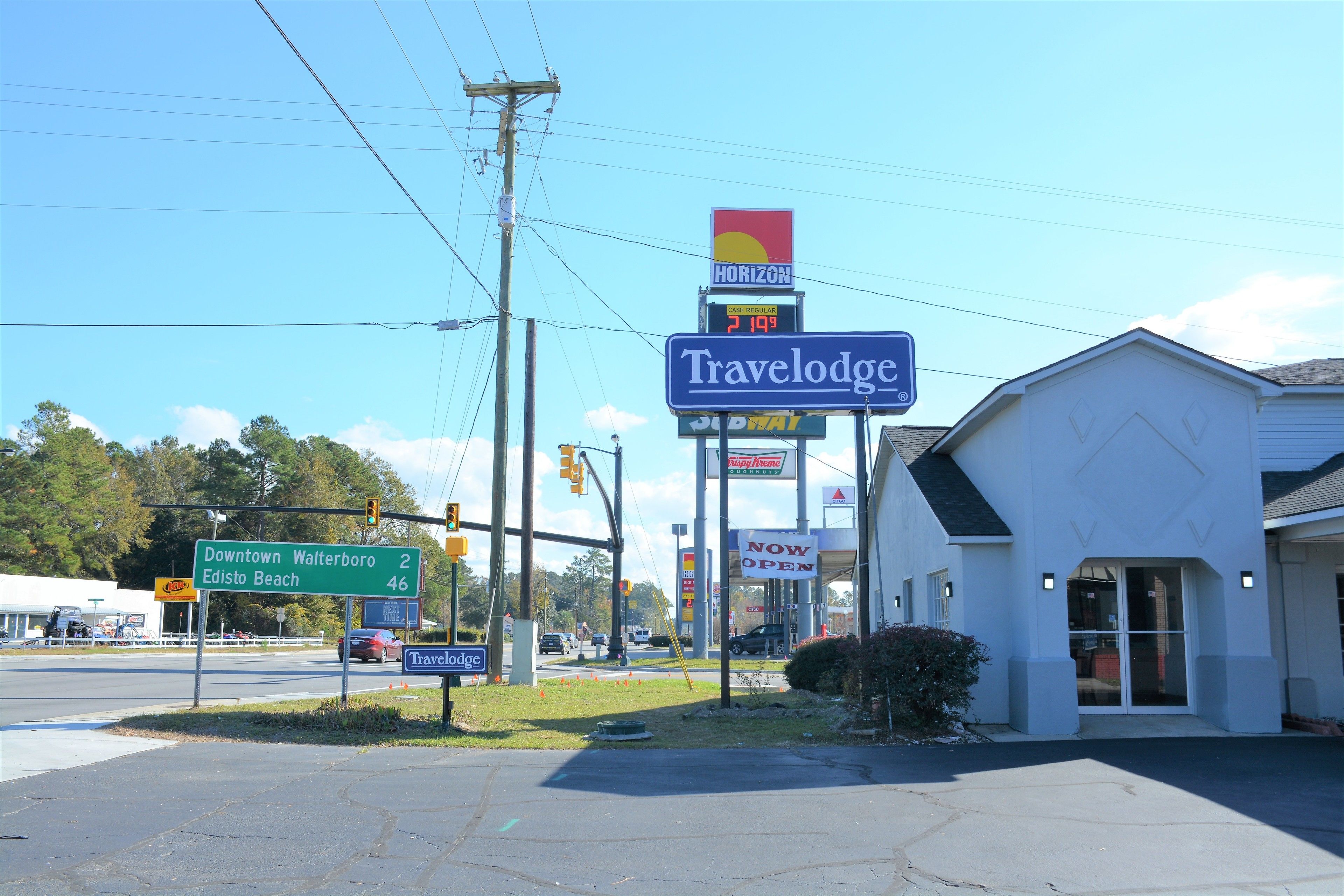 A Travelodge motel with a sign indicating a 2-mile distance to Downtown Walterboro and Edisto Beach.