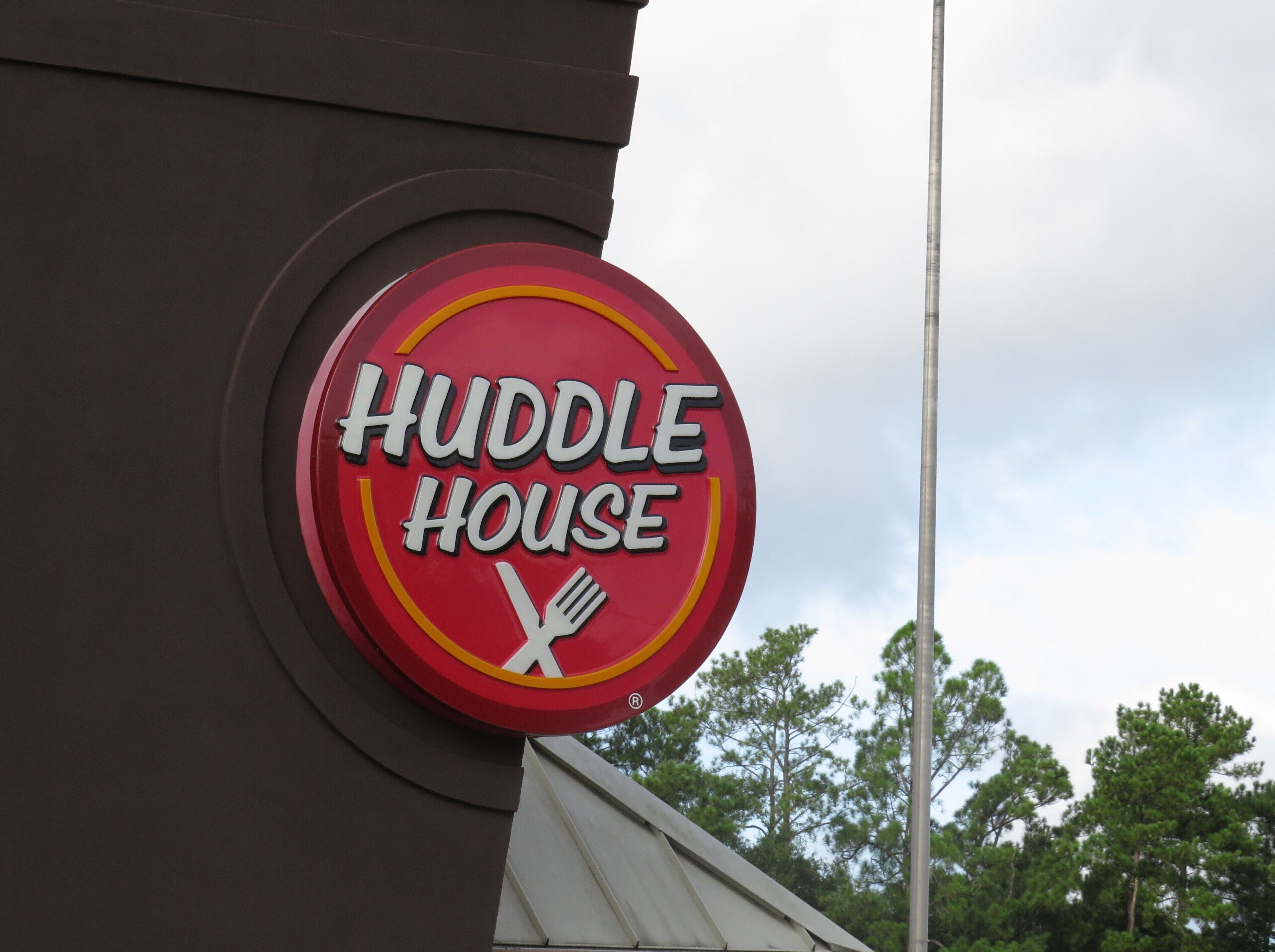 A Huddle House sign on a building.