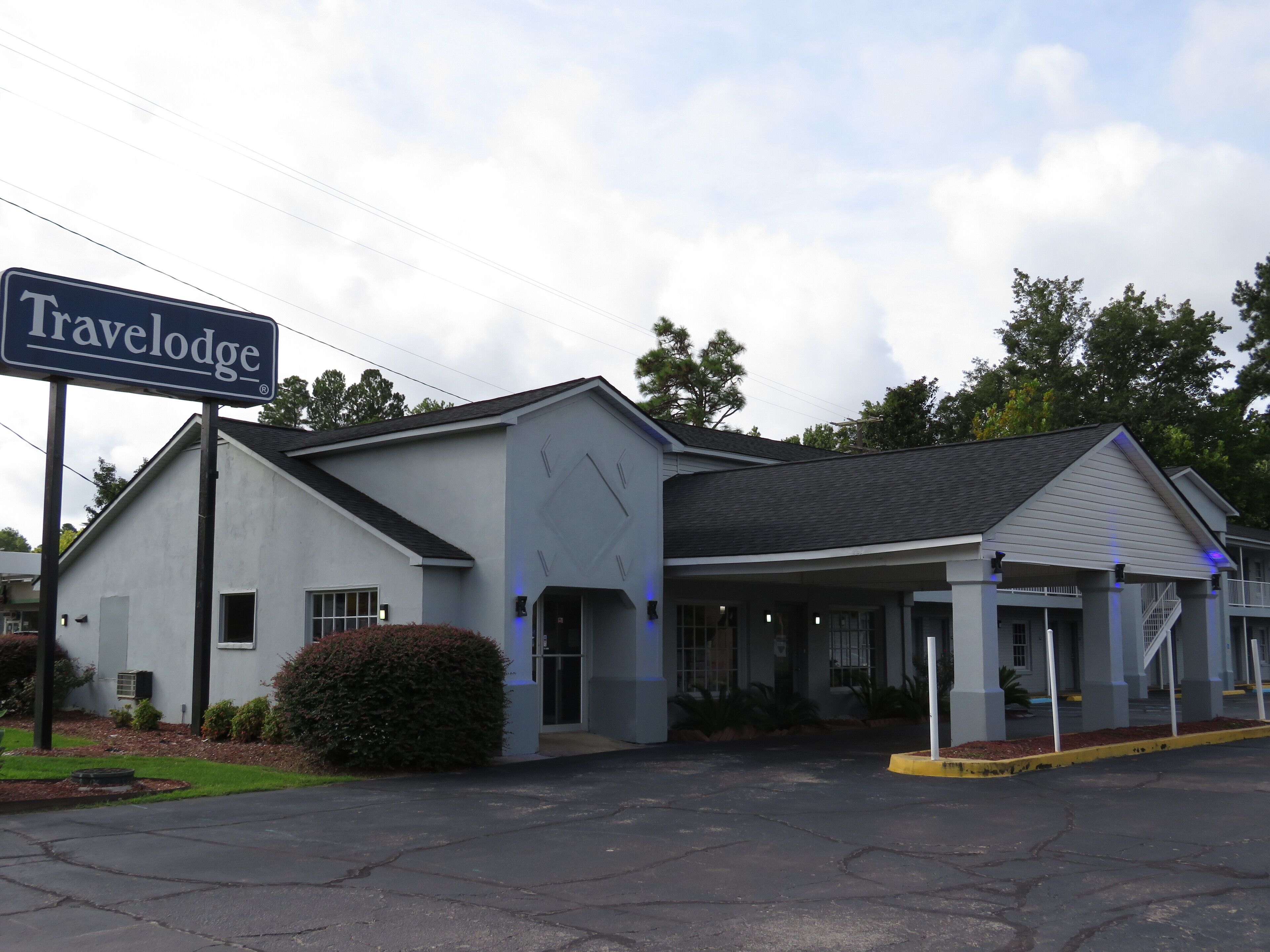 A Travelodge motel with a covered parking area and a single-story building.
