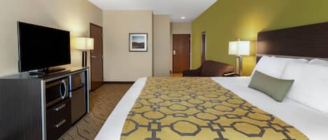 A hotel room with a bed, a television, a desk, and a chair.