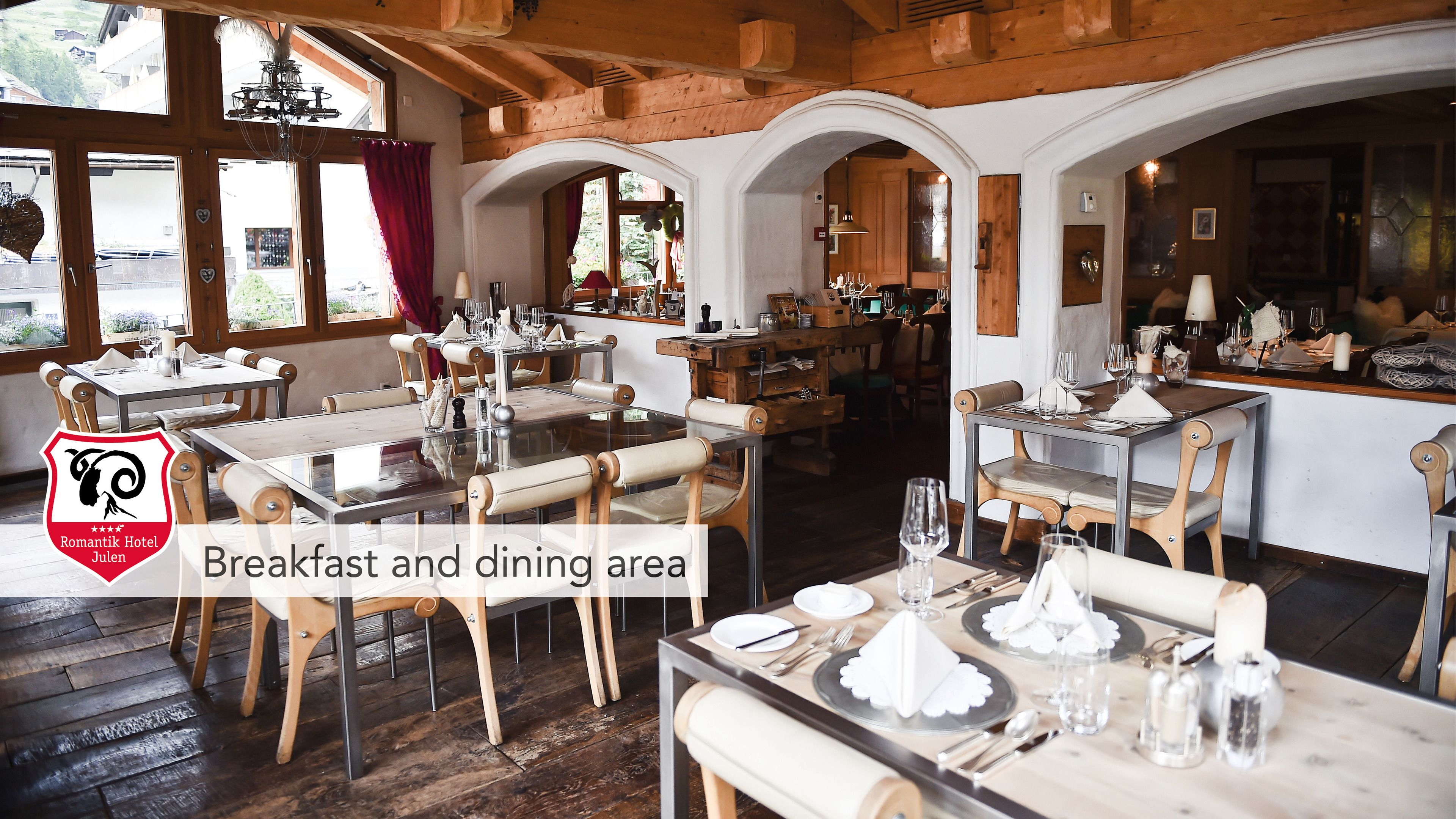 Un área de desayuno y comedor en el Hotel Romantik Julius, con mobiliario de madera y una decoración rústica.
