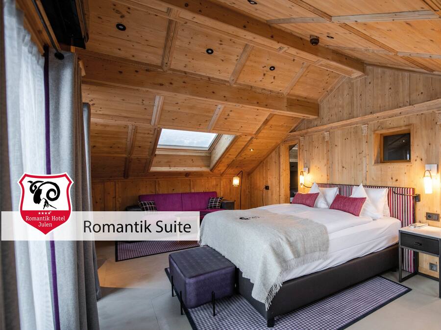 A cozy room with a bed, a bench, and a window.
