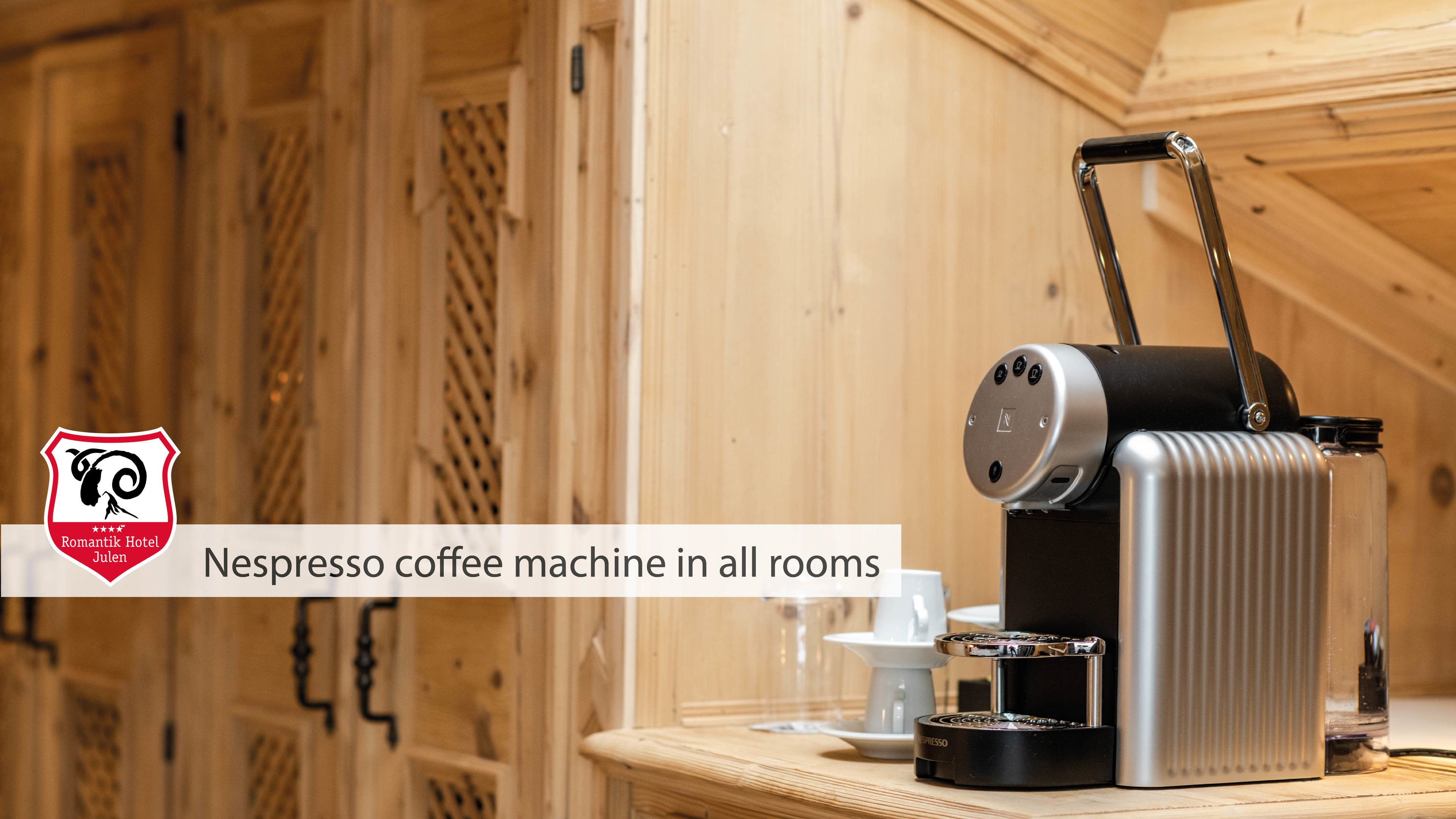 A Nespresso coffee machine in a room with wooden paneling.