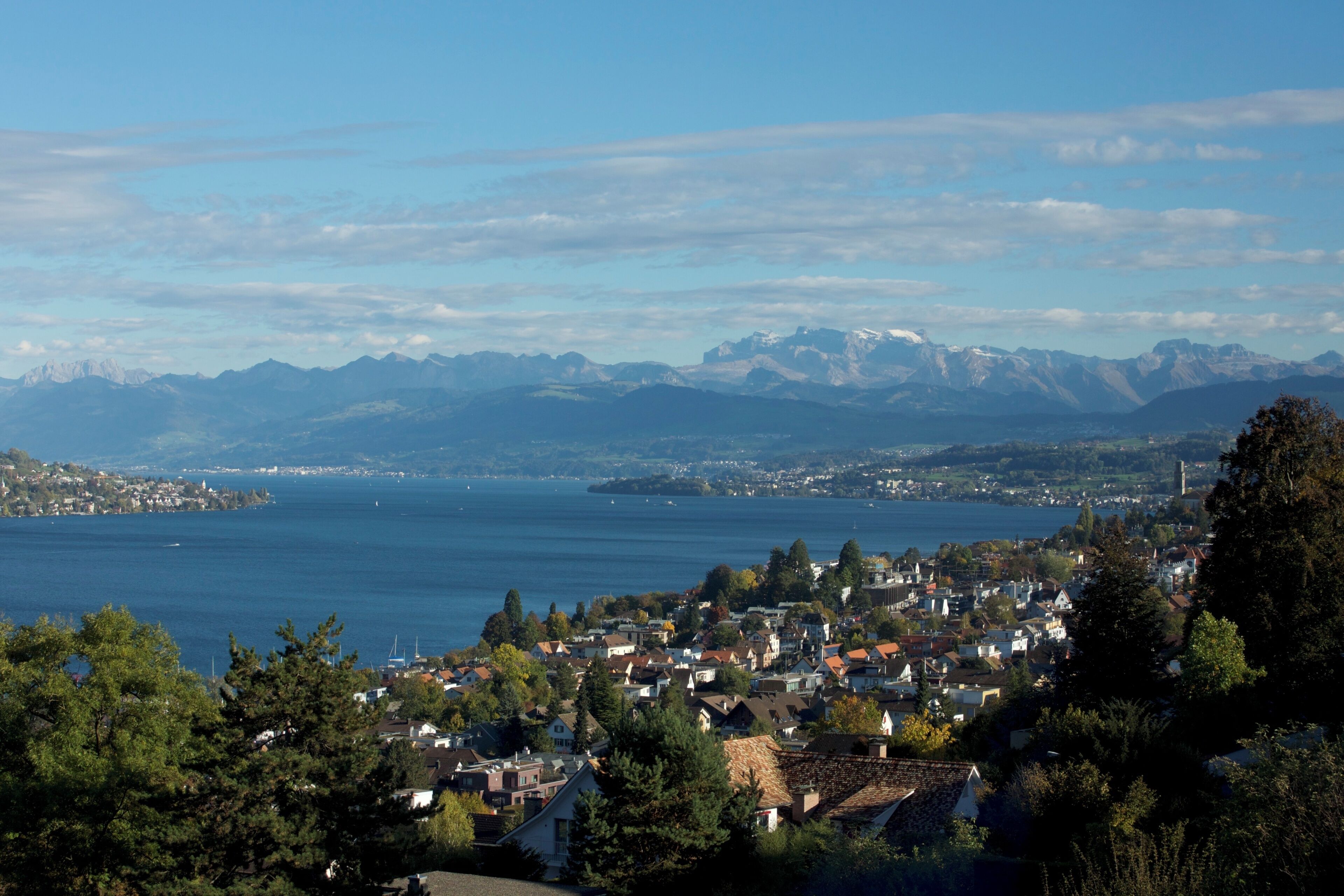 A coastal town with a view of mountains and a lake.