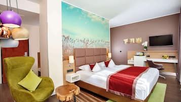 Relax in a spacious room with a large bed, flat-screen TV, and comfortable seating area.