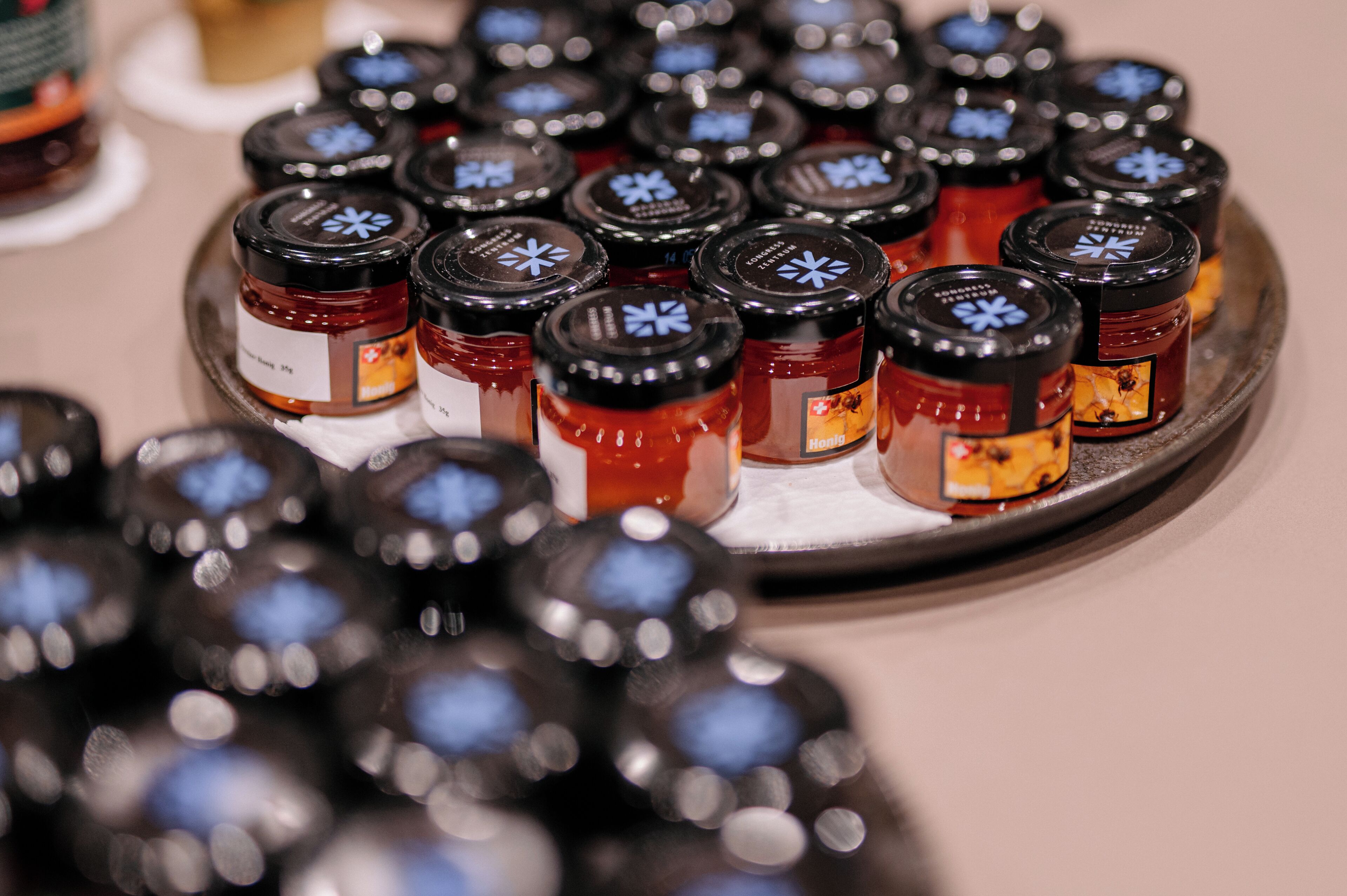 A tray of small jars with labels, likely containing condiments or preserves.