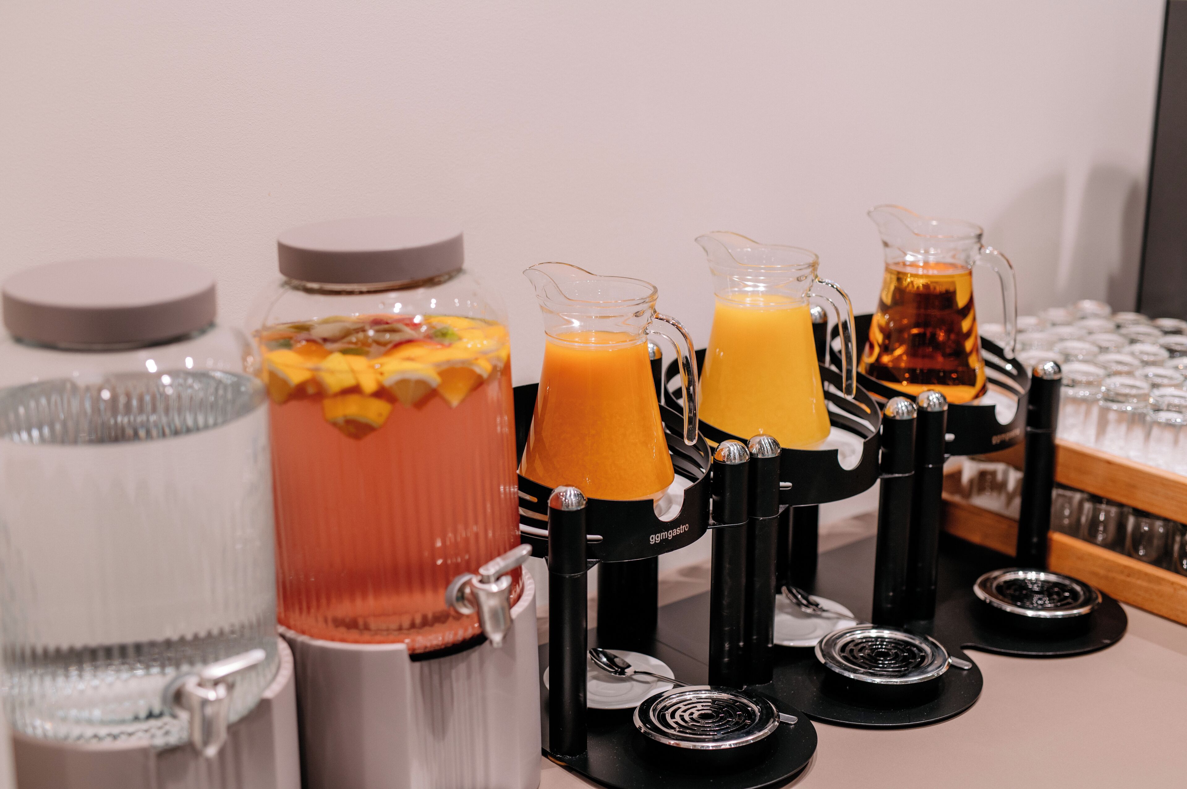 A beverage station with various drink dispensers and a large water dispenser.