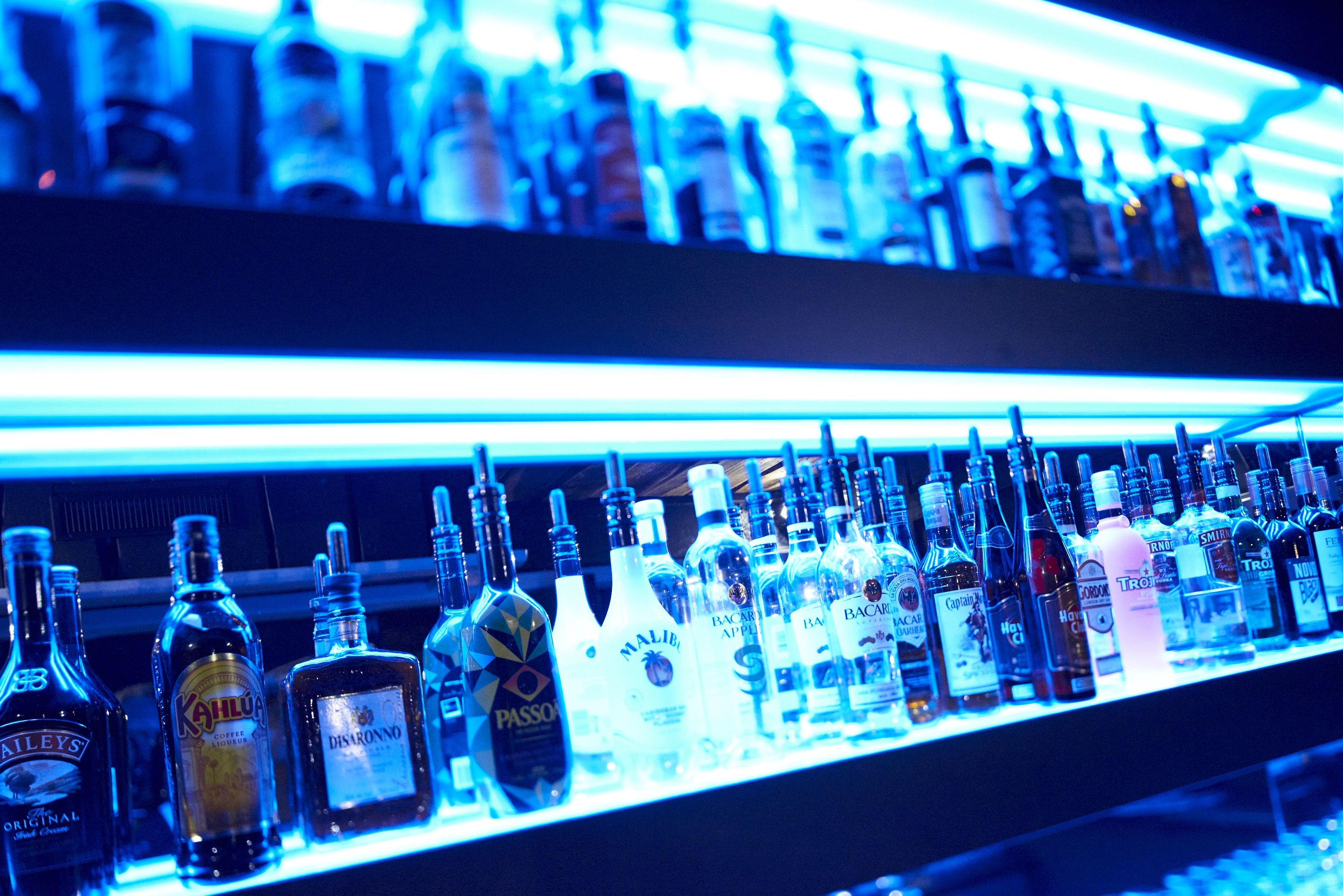 A bar with various liquor bottles displayed on shelves.