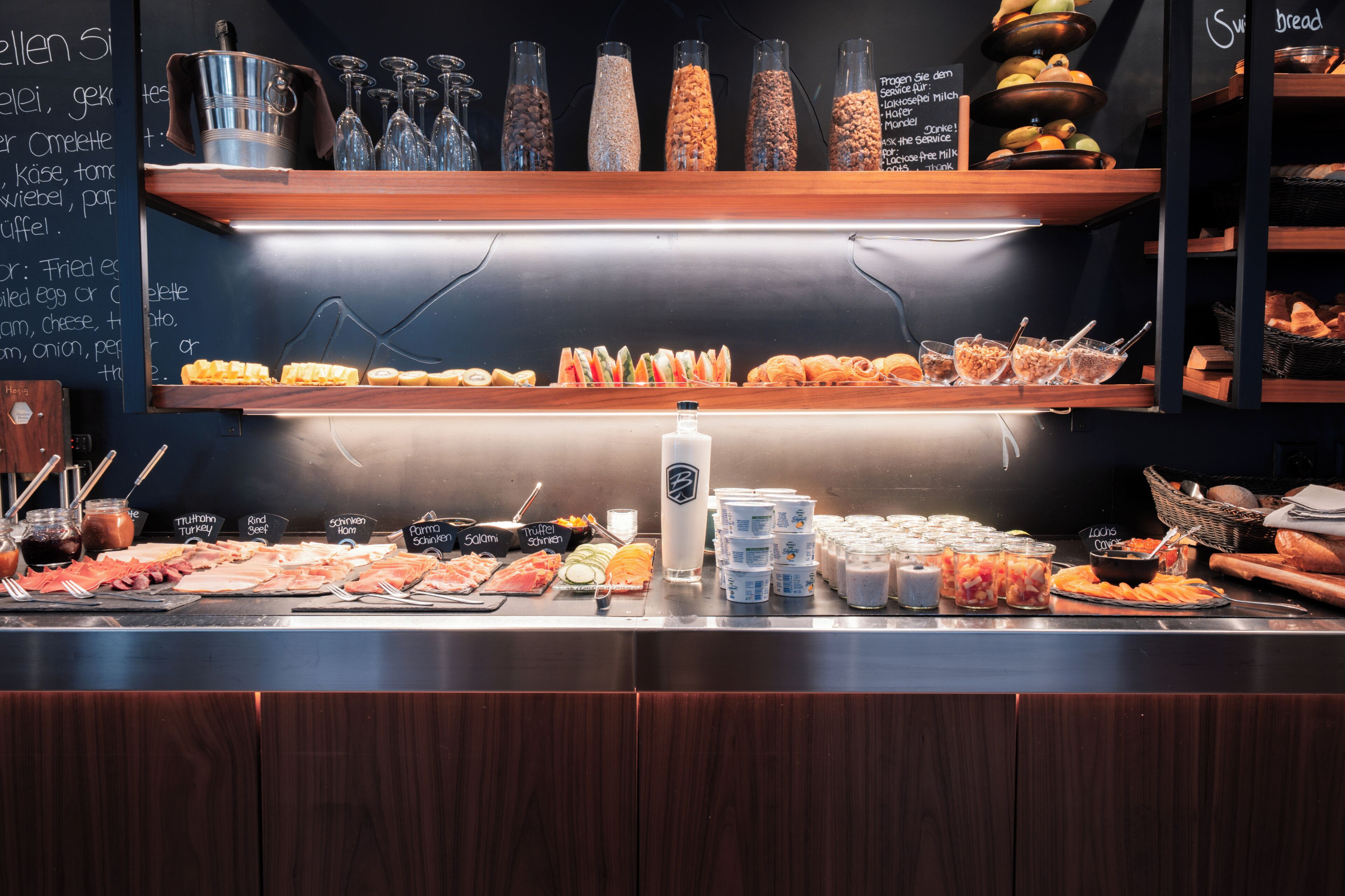 A buffet with various food items and condiments.
