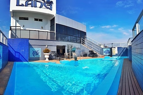 Seasonal outdoor pool, open 9:00 AM to 10:00 PM, pool umbrellas