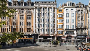A historic building with a prominent "HOTEL CHAGNOT" sign, large windows, and a classic architectural style.