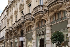 A historic building with ornate architectural details, including columns and balconies. The building houses a hotel named 'HOTEL DANIEL' and a store named 'KOOKAI'.
