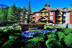 A lodge with a sign reading "Pemberton Valley Lodge" surrounded by well-maintained landscaping and a mountainous backdrop. - Pemberton Valley Lodge (Pemberton)