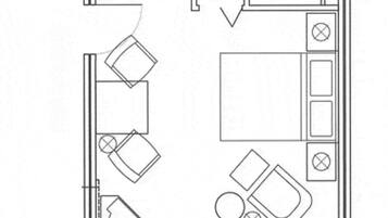 A floor plan of a hotel room with a kitchenette, a bathroom, a seating area, and a small table.