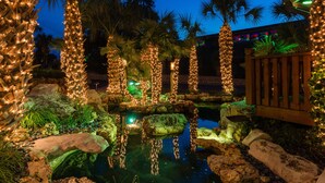 A nighttime garden with illuminated trees and a pond. - Horseshoe Bay Resort (Horseshoe Bay)