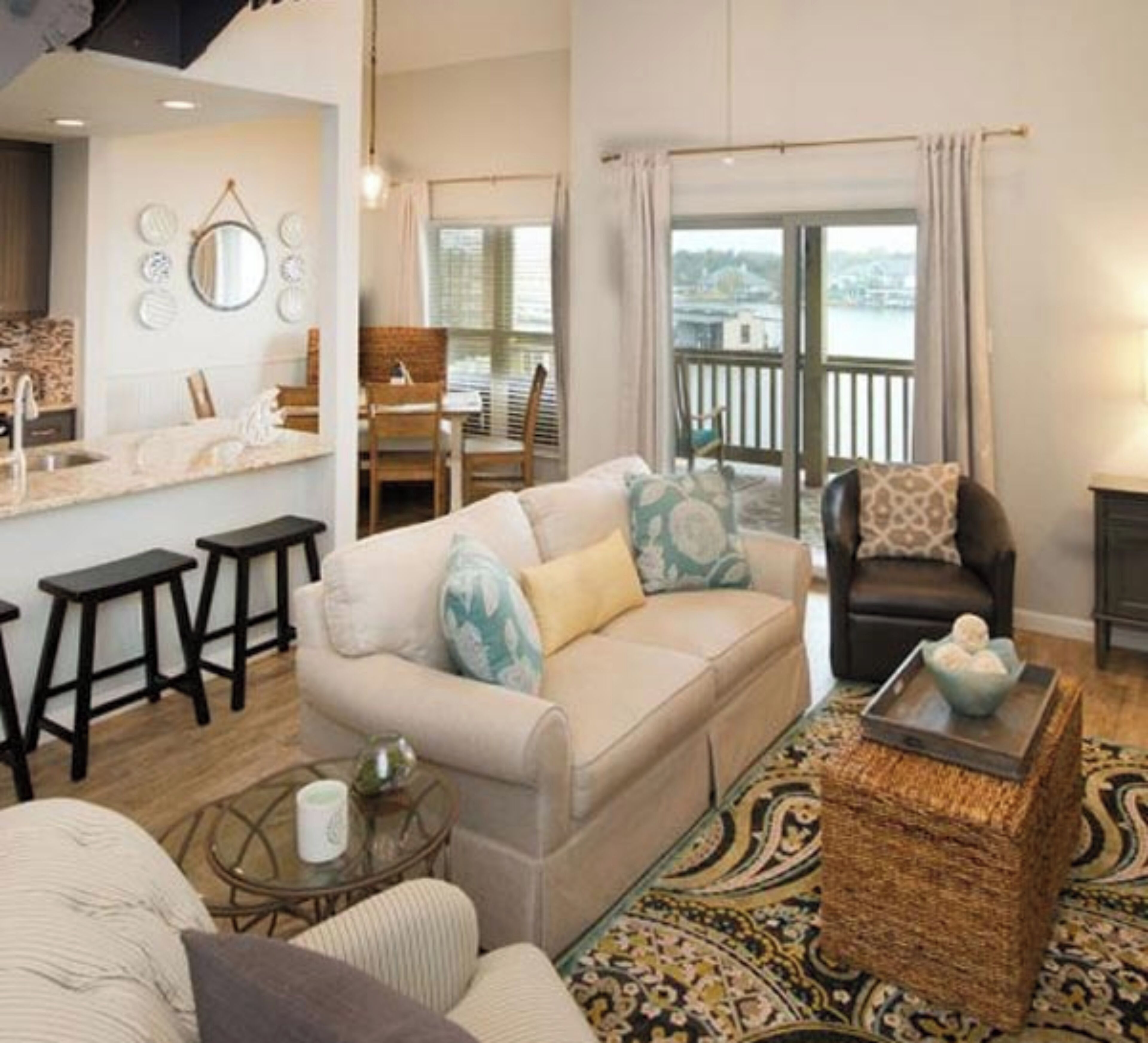 A cozy living room with a sofa, armchairs, a coffee table, and a dining area with chairs and a table.