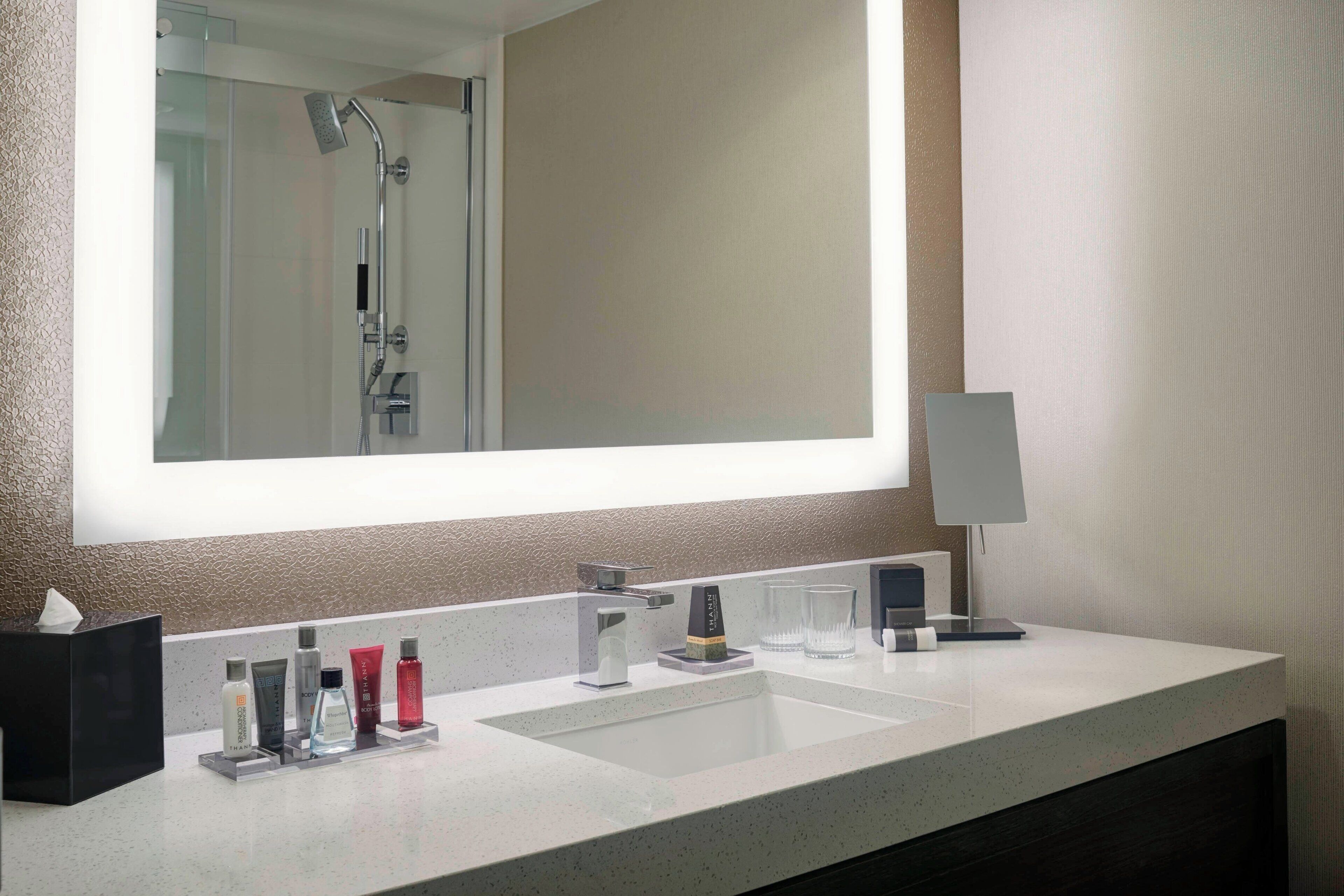 combined shower/bathtub, designer toiletries, hair dryer, towels