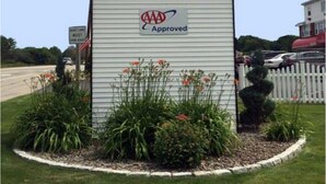 A sign for Coachman Inn with a logo and an AAA Approved badge. - Coachman Inn (Kittery)