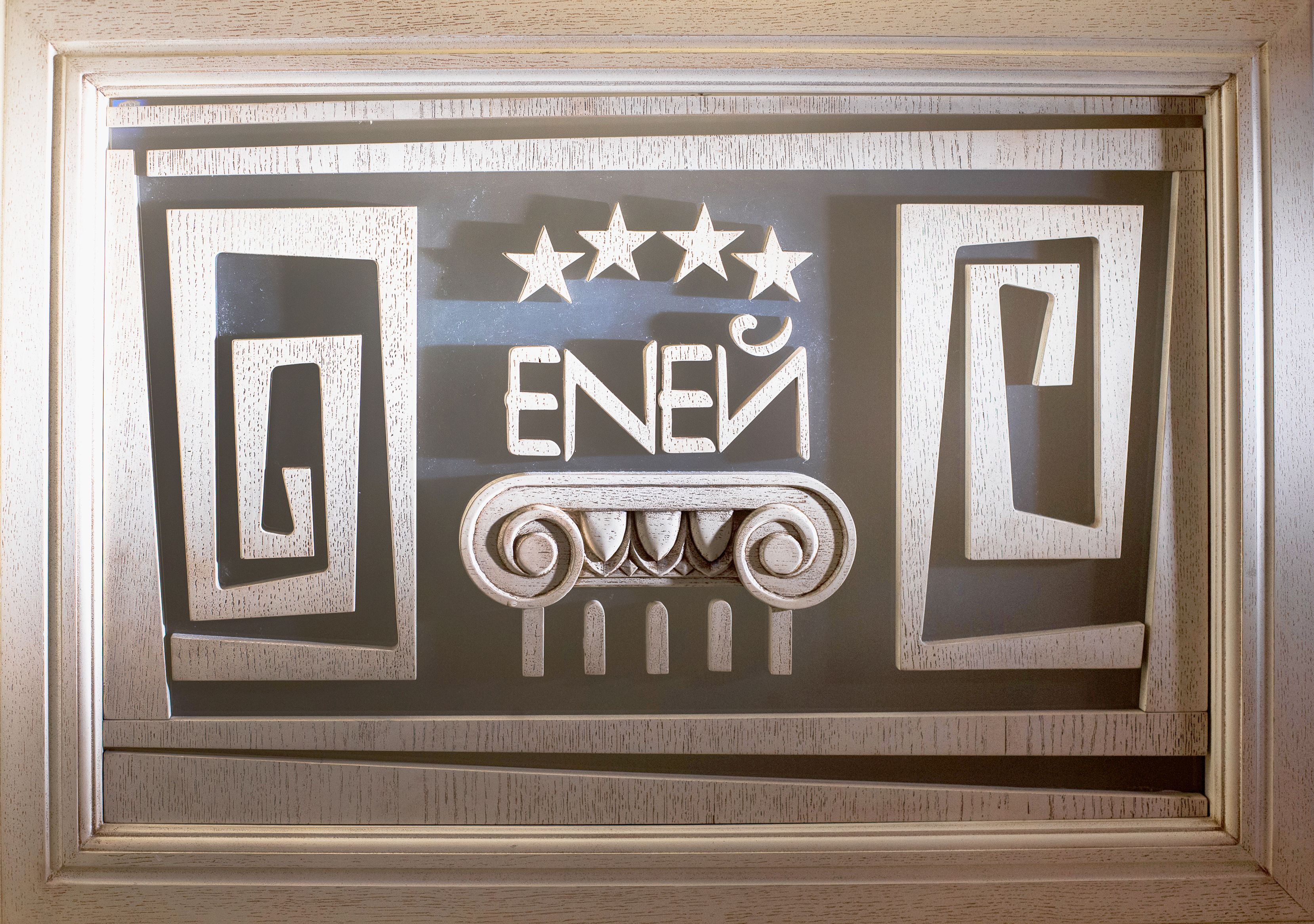 A framed decorative panel with the word "ENEI" and three stars above it.