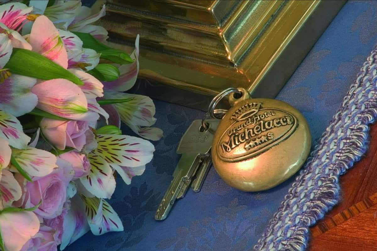 A key, a keychain, and a decorative item with hotel branding.