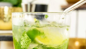 A glass of a green beverage with mint leaves and ice cubes. - ibis Swansea (Swansea)