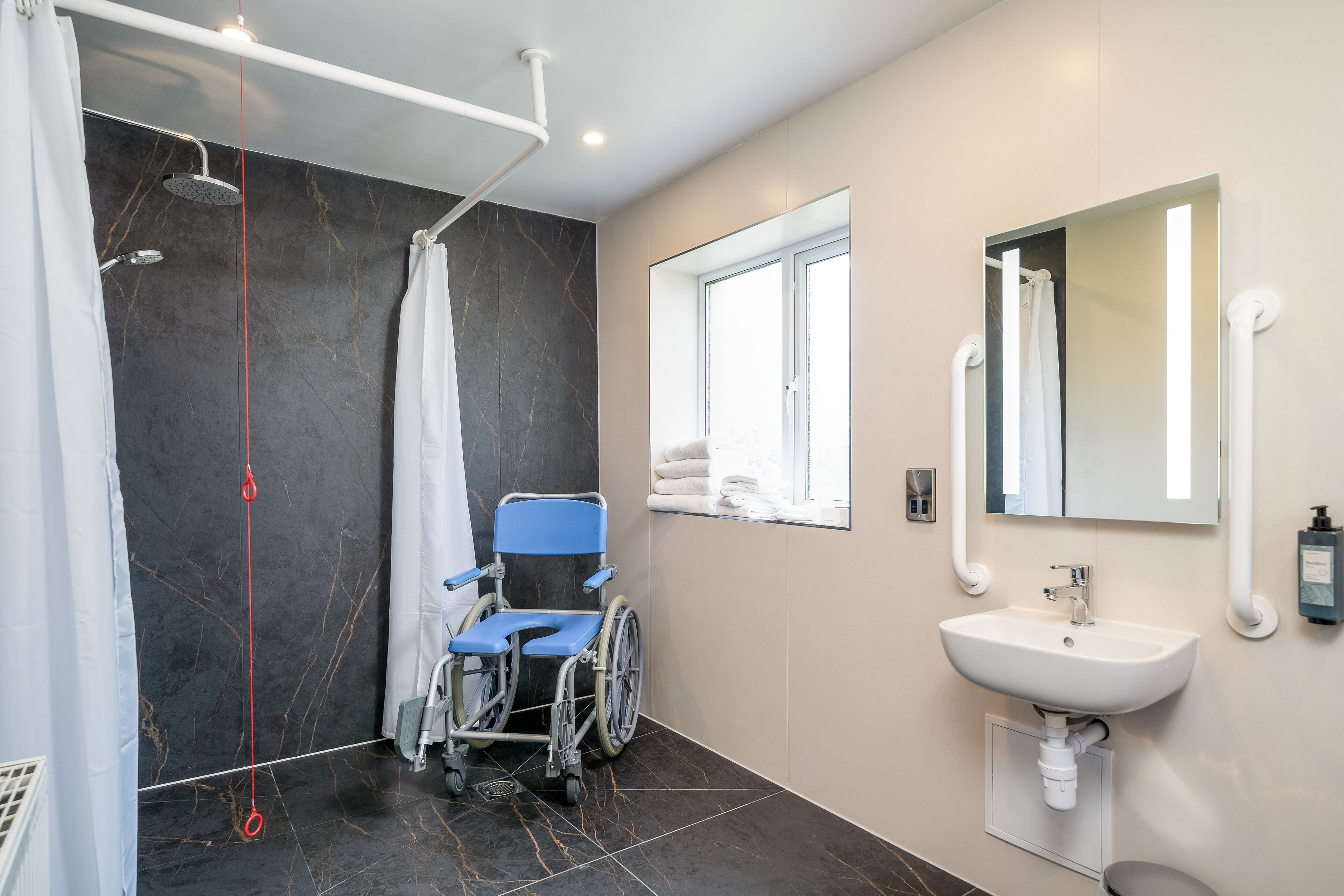 accessible twin room with walk in shower | bathroom | free toiletries, hair dryer, towels