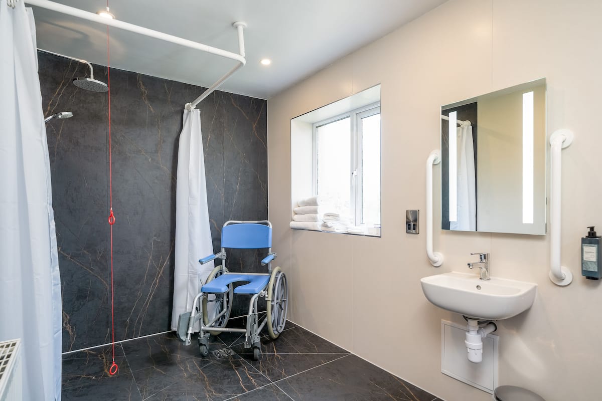 accessible twin room with walk in shower | bathroom | free toiletries, hair dryer, towels