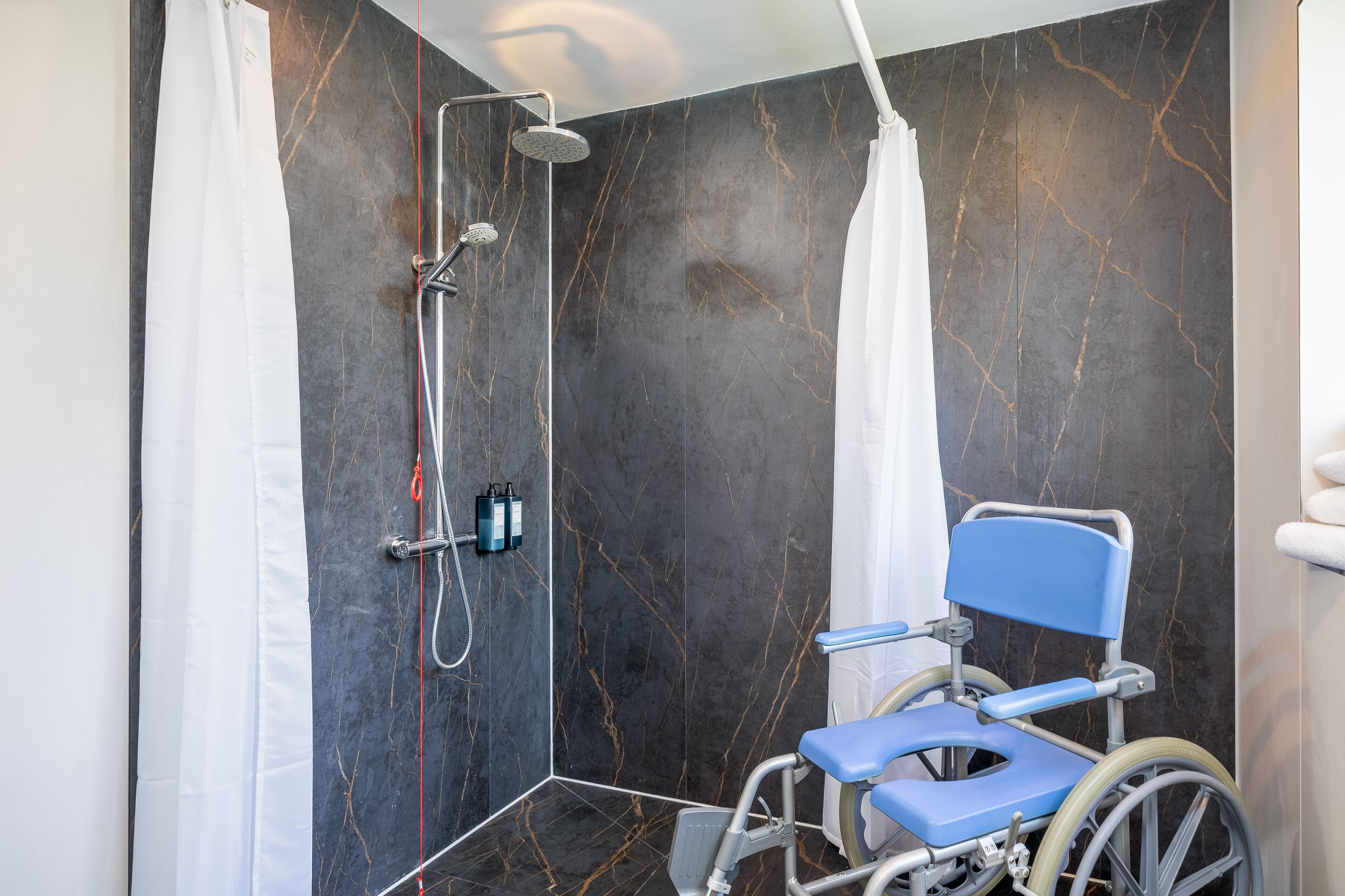 accessible twin room with walk in shower | bathroom | free toiletries, hair dryer, towels