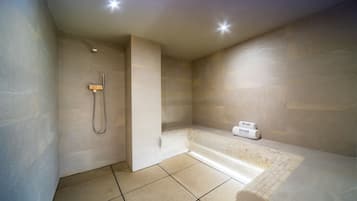 A modern bathroom with a shower, a bathtub, and a toilet.