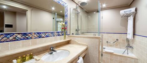 A bathroom with a sink, mirror, shower, and bathtub.