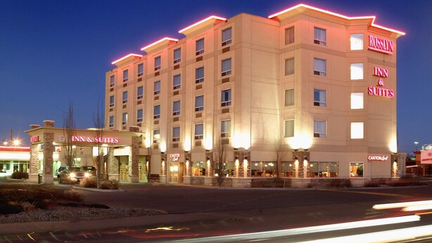 A multi-story hotel with a prominent signage for 'Rosslyn Inn & Suites' and 'Canyon Inn'. - Rosslyn Inn and Suites (Edmonton)