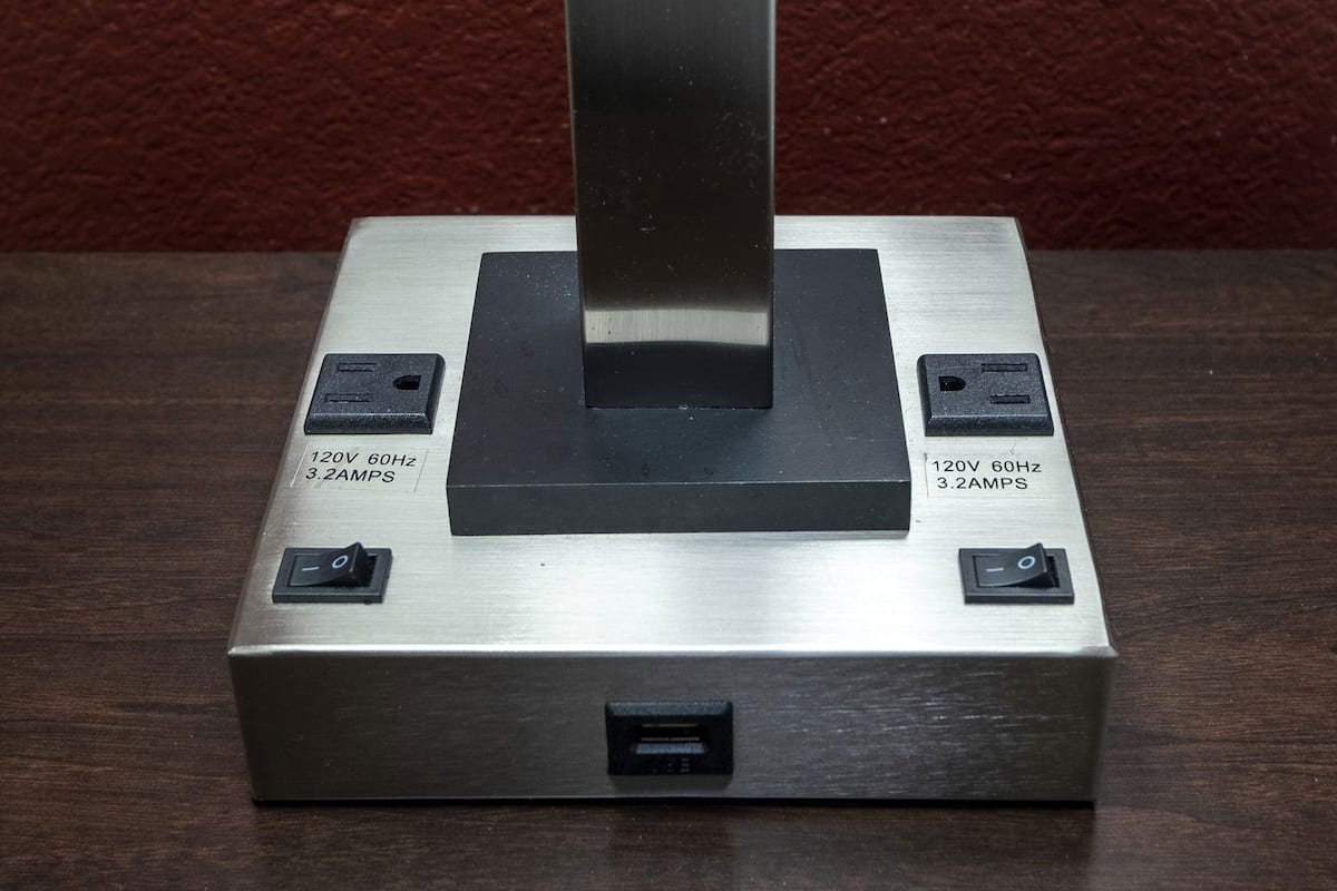 A metallic object with two power outlets, each labeled '120V 60Hz 3.2 AMPS,' and a USB port at the bottom.