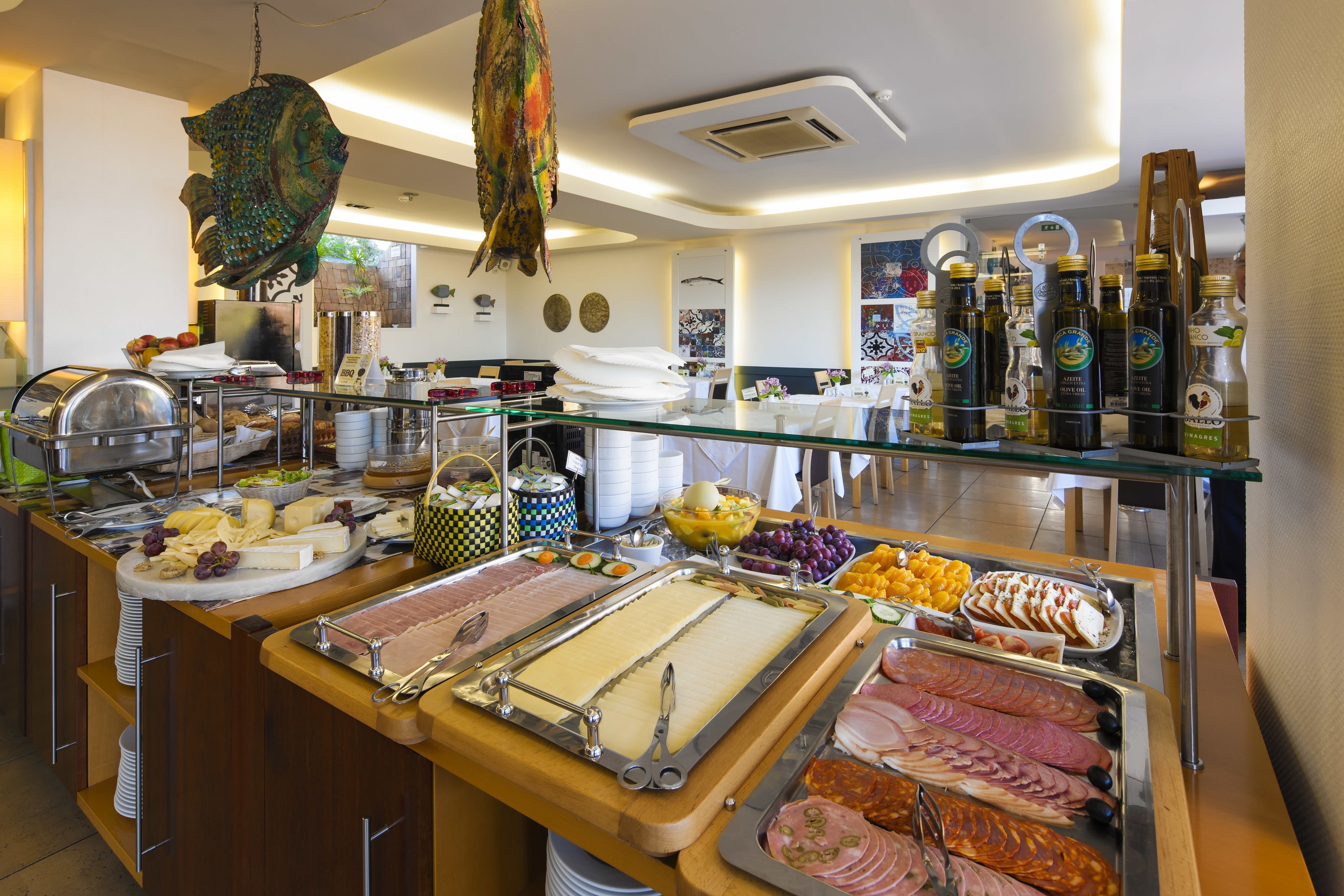 A buffet with various food items and a decorative hanging fish.