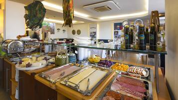 A buffet with various food items and a decorative hanging fish.