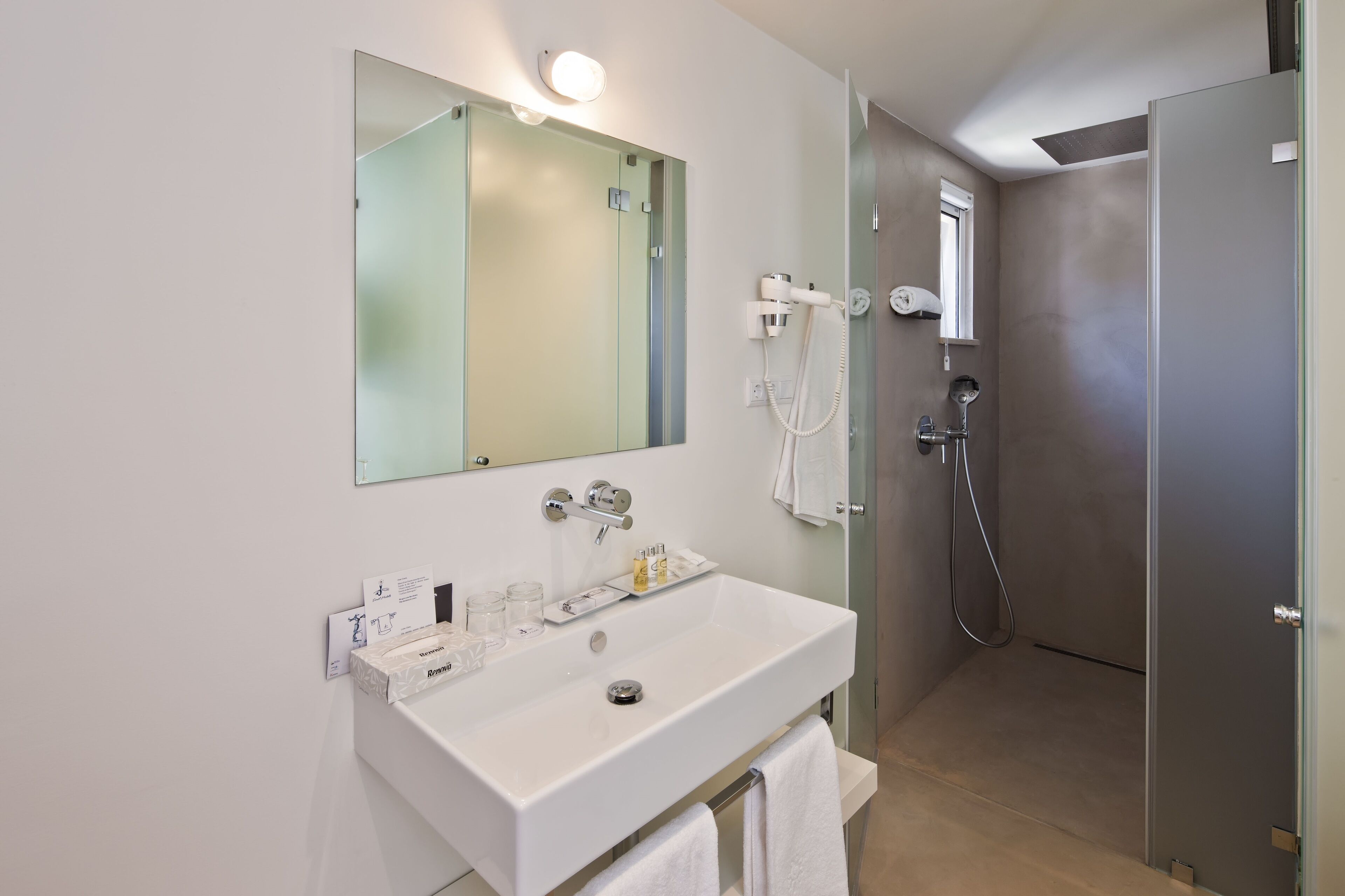 deluxe double or twin room | bathroom | rainfall showerhead, eco-friendly toiletries, hair dryer, towels