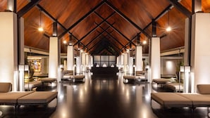A spacious lobby with a high ceiling and a central reception desk. - Twinpalms Surin Beach Phuket (Choeng Thale)