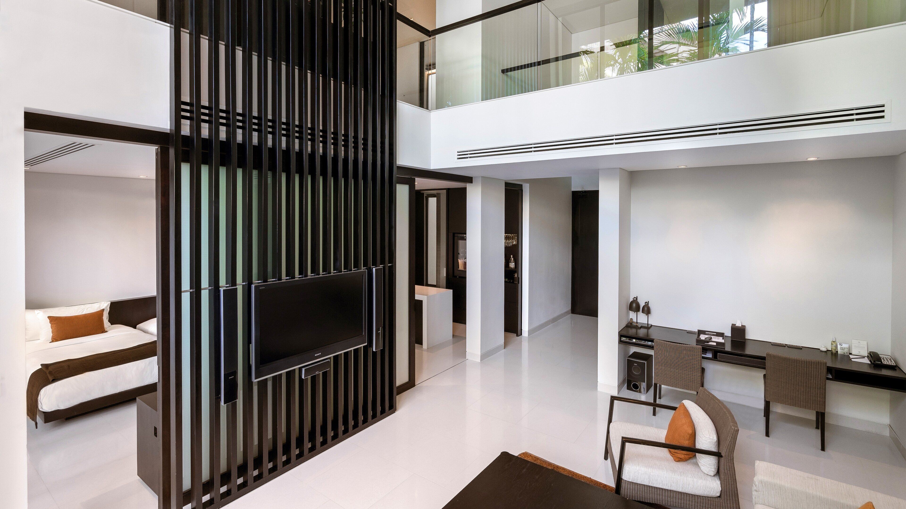 A modern interior with a flat-screen TV, a dining area, and a seating space.