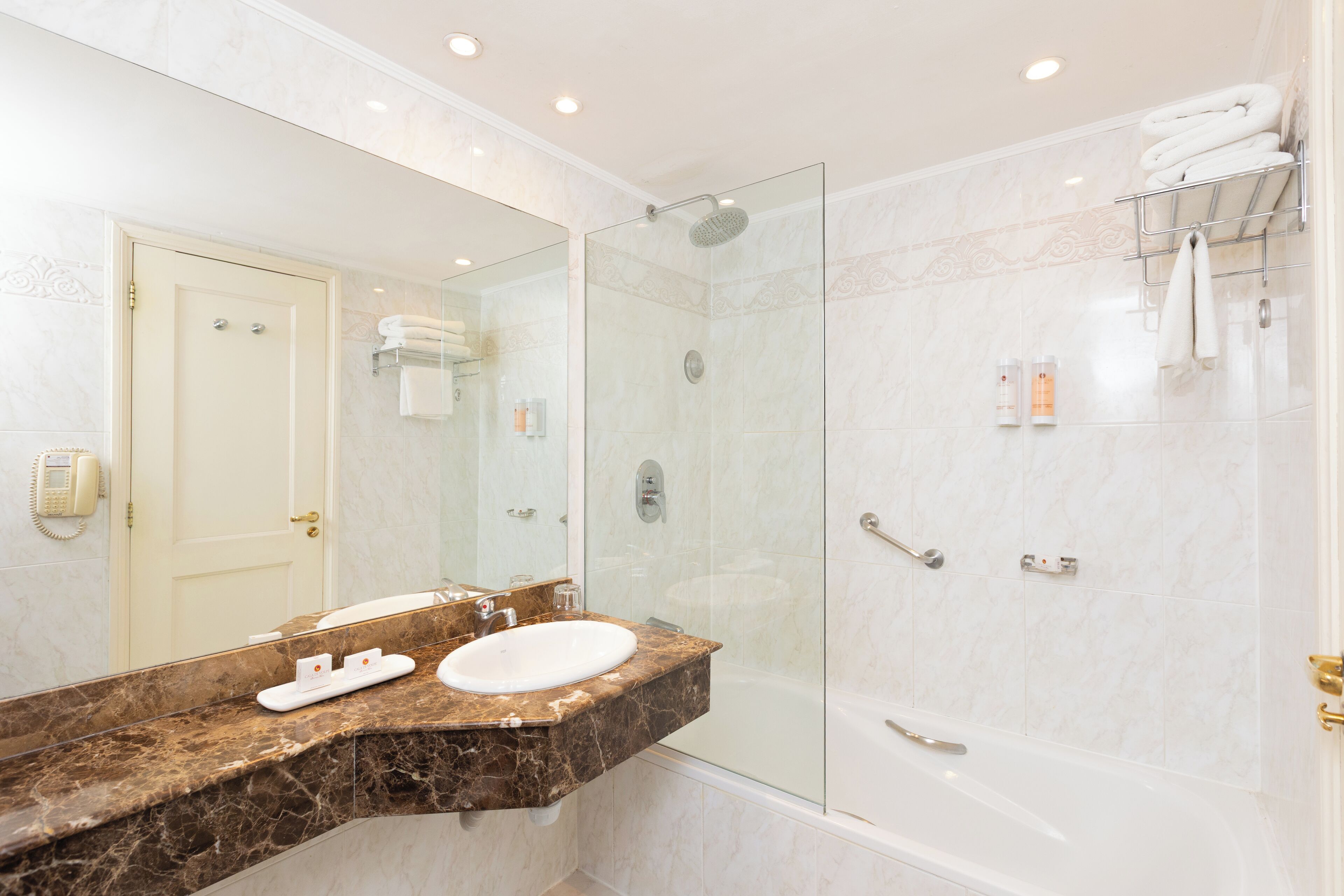 combined shower/bathtub, designer toiletries, hair dryer, bathrobes