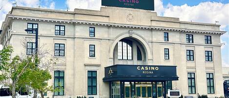 A large, historic building with a prominent arched entrance and a sign reading "CASINO REGINA".