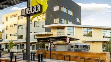 A modern building with a sign reading "The Lark" and a number "122" indicating its address.