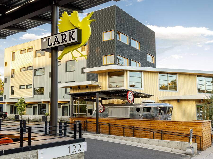 A modern building with a sign reading "The Lark" and a number "122" indicating its address.
