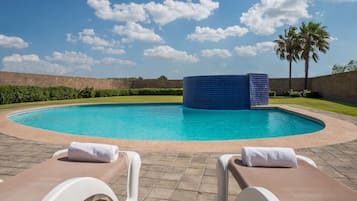 Outdoor pool, open 7:00 AM to 8:00 PM, pool loungers