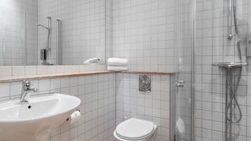 A bathroom with a sink, toilet, and shower.