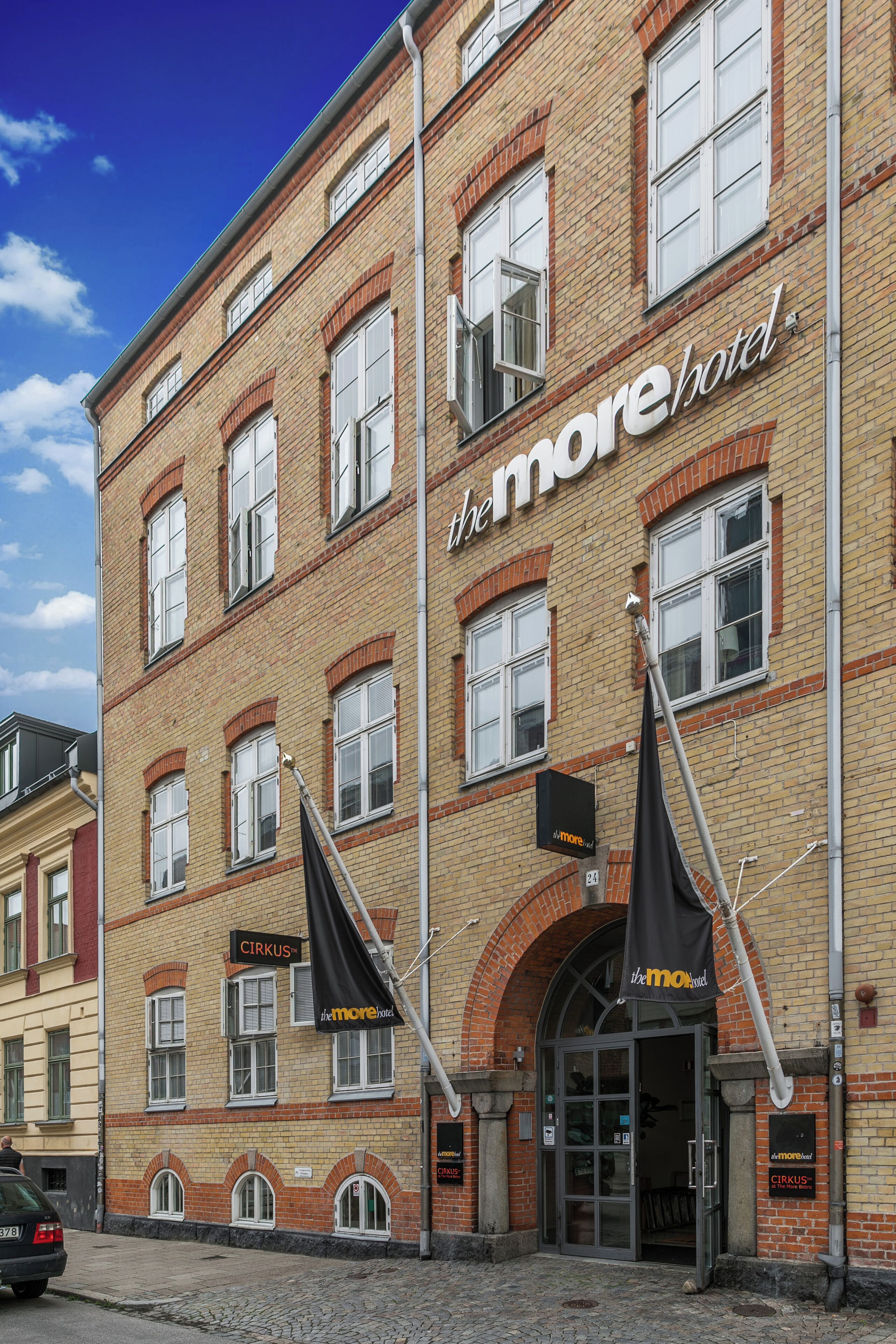 A historic building with a sign for 'The More Hotel' and 'CIRKUS' restaurant.