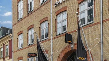 A historic building with a sign for 'The More Hotel' and 'CIRKUS' restaurant.